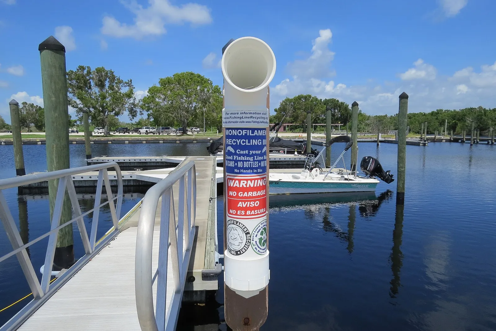White PVC monofilament recycling tube on a dock beside the water