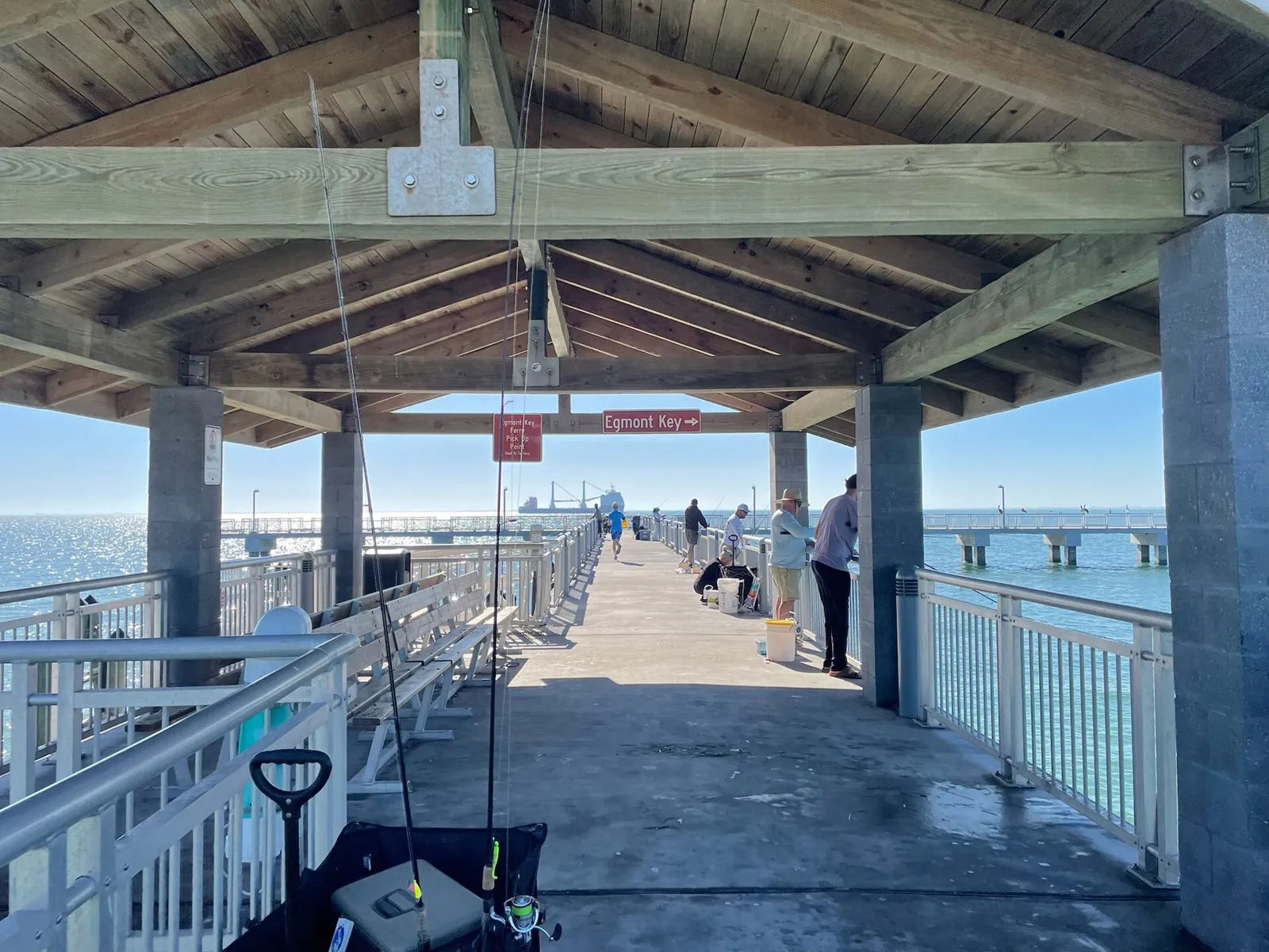 Covered walkway of the Bay Pier at Fort De Soto Park with anglers fishing along the rails